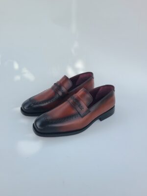 Close-up of brown leather loafers stitching and texture